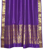 Purple sari ring top curtains hung at a window