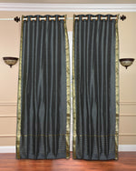 Grey sari grommet top curtains hung at a window