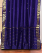 Purple sari grommet top curtains hung at a window