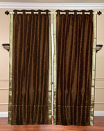 Brown sari grommet top curtains hung at a window