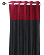 Burgundy velvet ring top curtains hung at a window