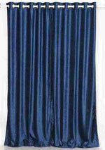 Navy blue velvet grommet top curtains hung at a window