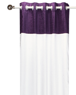 Purple velvet ring top curtains hung at a window