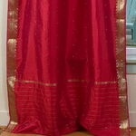 Fire brick sari tie top curtains hung at a window