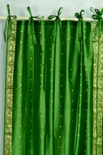 Forest green sari tie top curtains hung at a window