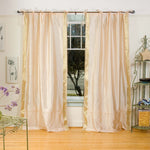 Golden sari tie top curtains hung at a window