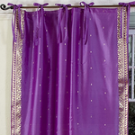 Lavender sari tie top curtains hung at a window