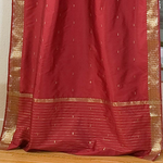 Maroon sari tie top curtains hung at a window