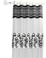 Black sheer tissue ring top curtains hung at a window