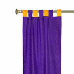 Purple sari tab top curtains hung at a window