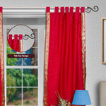 Maroon sari tab top curtains hung at a window