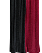 Burgundy velvet ring top curtains hung at a window
