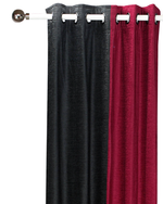 Burgundy velvet ring top curtains hung at a window