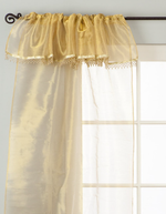 Golden rod sheer tissue rod pocket curtains hung at a window