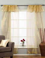 Golden rod sheer tissue rod pocket curtains hung at a window