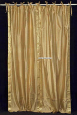 Golden sari tie top curtains hung at a window