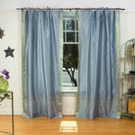 Gray sari tie top curtains hung at a window