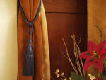 Gray sari curtain tiebacks holding a panel open