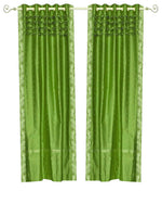 Forest green sari grommet top curtains hung at a window