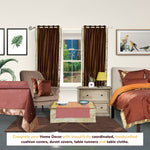 Brown sari grommet top curtains hung at a window