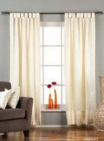 Cream sari tab top curtains hung at a window