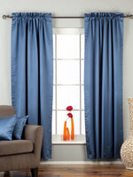 Blue sari rod pocket curtains hung at a window