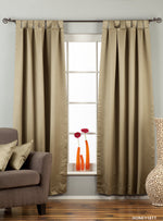 Olive green sari tab top curtains hung at a window
