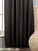 Black sari grommet top curtains hung at a window