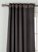 Black sari grommet top curtains hung at a window