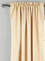 Golden rod sari rod pocket curtains hung at a window