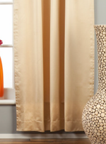 Golden sari tab top curtains hung at a window