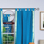 Turquoise sari tab top curtains hung at a window