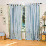 Gray sari tab top curtains hung at a window