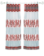 Maroon sheer tissue ring top curtains hung at a window