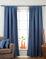 Blue raw silk tab top curtains hung at a window