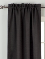 Black raw silk rod pocket curtains hung at a window
