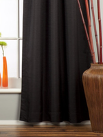 Black raw silk tab top curtains hung at a window
