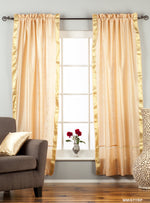 Misty rose sari rod pocket curtains hung at a window