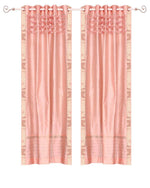Peach sari grommet top curtains hung at a window