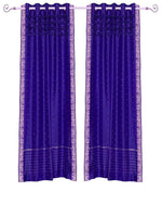 Purple sari grommet top curtains hung at a window