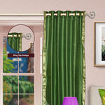 Forest green sari grommet top curtains hung at a window