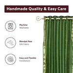Forest green sari grommet top curtains hung at a window
