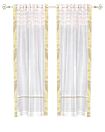 White sari grommet top curtains hung at a window