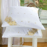 White sari cushion covers arranged on a sofa