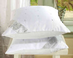 White sari cushion covers arranged on a sofa