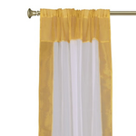 White sheer tissue rod pocket curtains hung at a window