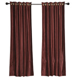 Wine velvet grommet top curtains hung at a window