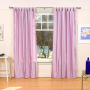 Lilac velvet tab top curtains hung at a window