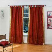 Rust sari tab top curtains hung at a window