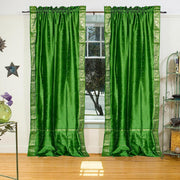 Forest green sari rod pocket curtains hung at a window